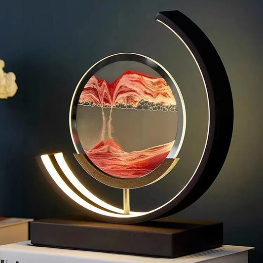 Duna moving sand lamp with a sand landscape behind glass