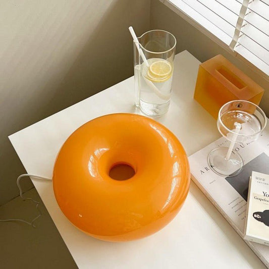 Ring Bauhaus donut lamp as a wall light with an amber glow