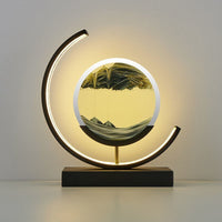 Duna moving sand lamp next to books on a shelf