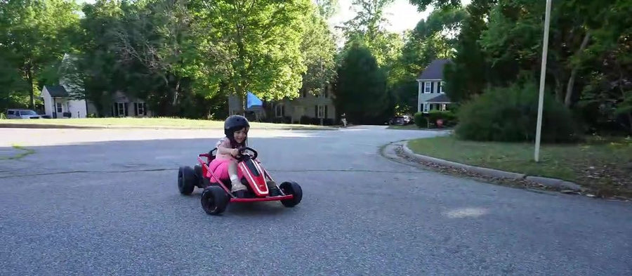 Kid driving the Apex 24V drift kart around a street corner