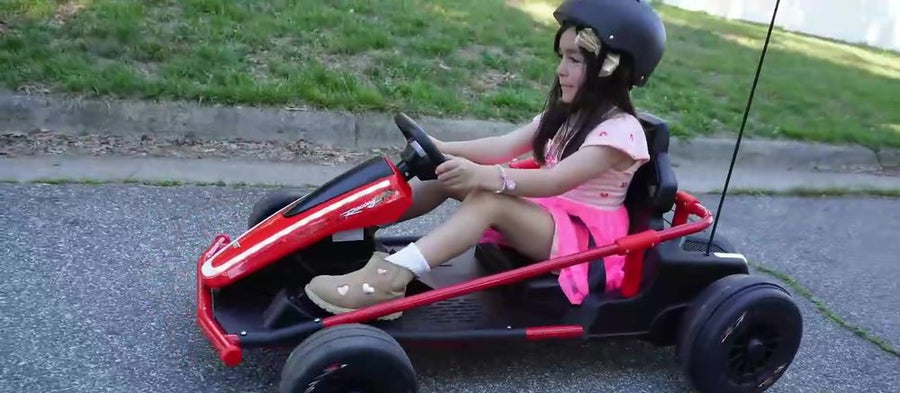 Girl in a helmet driving the Apex kart