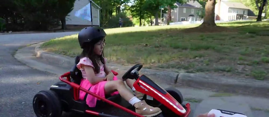 Girl driving the kart with the 2.4GHz parent remote in view