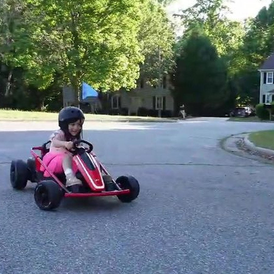 Girl driving a red electric drift kart