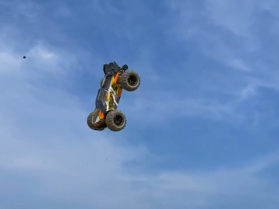 BlueBolt brushless RC car in mid-air jump