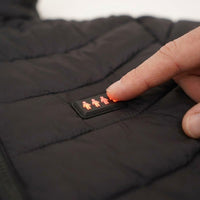 Finger pressing the lit heat control button on the jacket chest